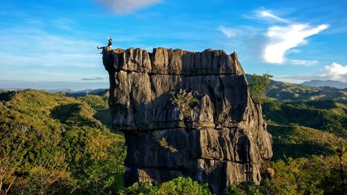 Rock formations on landscape against sky
