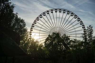 Low angle view of ferris wheel against sky