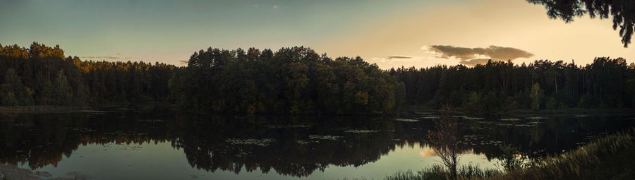 Scenic view of lake against sky at sunset