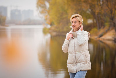 Elegante blondy woman walking and relaxing outdoors in autumn