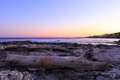 Scenic view of sea against clear sky during sunset