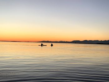 Scenic view of sea against orange sky