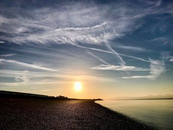 Scenic view of vapor trail in sky during sunset