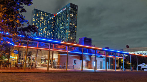 Illuminated buildings against sky at night