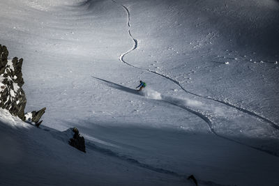 Person skiing on snowcapped mountain