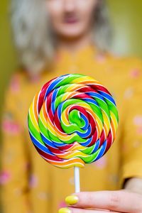 Midsection of woman holding lollipop