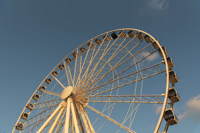 Low angle view of ferris wheel against sky