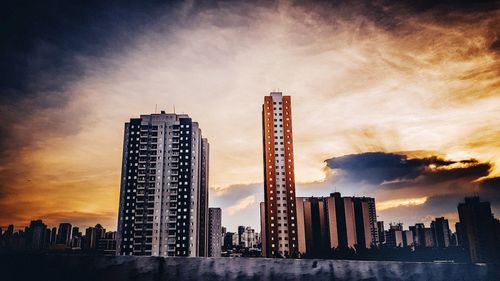 Low angle view of buildings against sky during sunset