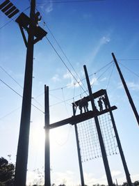 Low angle view of crane against sky