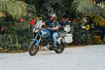 Man riding motor scooter on street