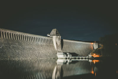 High angle view of dam on lake against sky at night