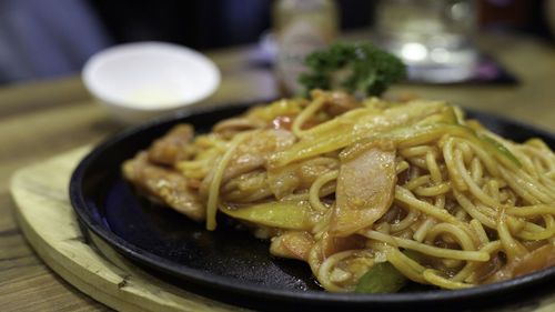 Close-up of noodles in plate on table at restaurant