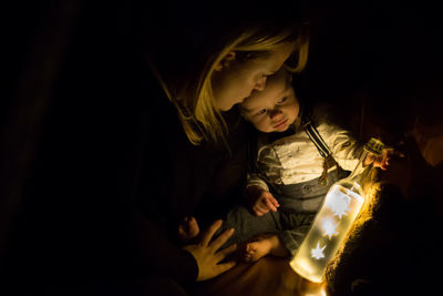 Girl looking at illuminated lighting equipment