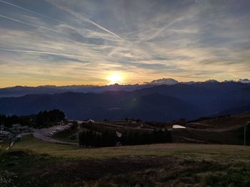 Scenic view of field against sky during sunset