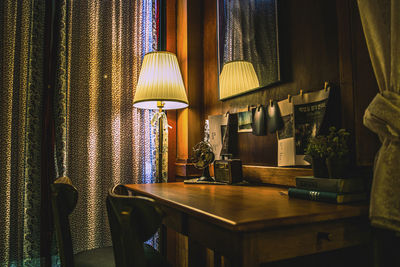 Illuminated electric lamp on table at home