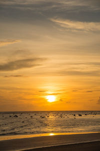 Scenic view of beach against sky during sunset