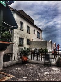 Buildings against cloudy sky
