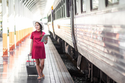 Rear view of woman standing in subway