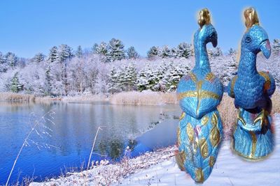 Scenic view of lake against clear blue sky