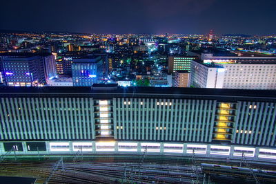 High angle view of illuminated buildings in city at night