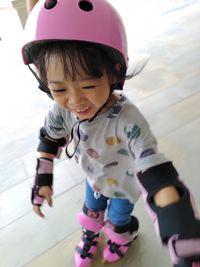 High angle view of cute girl roller skating on floor