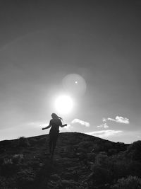 Man on golf course against sky