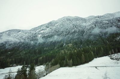 Close-up of snow on mountain against sky