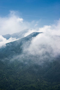 Scenic view of mountains against cloudy sky