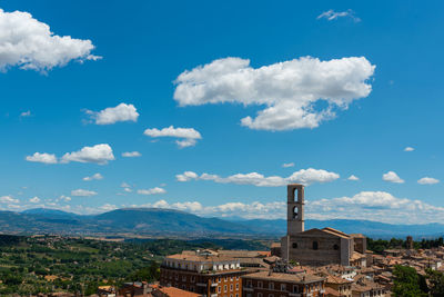 Aerial view of buildings in city against sky