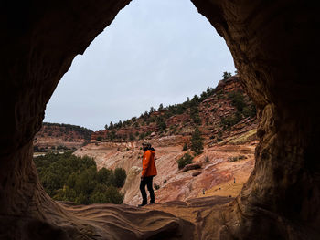 Rear view of man walking in cave