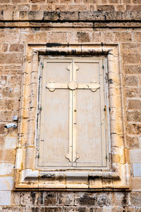 Low angle view of window on old building