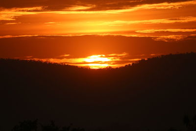 Scenic view of landscape against orange sky