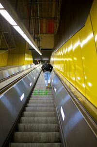 Low angle view of a person an an escalator