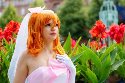 Woman with redhead wearing dress against plants