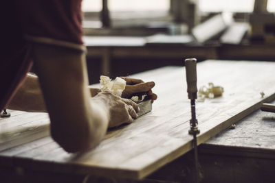 Close-up of man working on cutting board