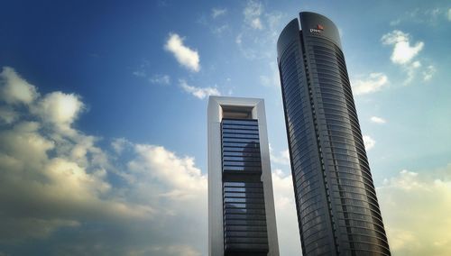 Low angle view of modern building against cloudy sky