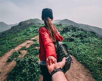 Low section of friends standing on mountain