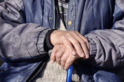 Midsection of senior woman wearing warm clothing