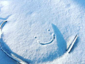 High angle view of footprints on snow covered land