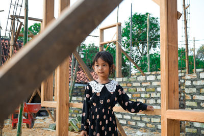 Portrait of young woman standing outdoors