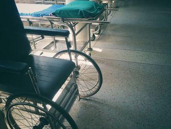 Bicycle parked on tiled floor against building