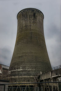 Low angle view of smoke stack against sky