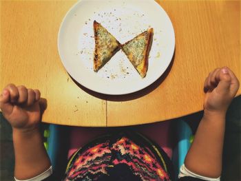 Low section of person holding food on table