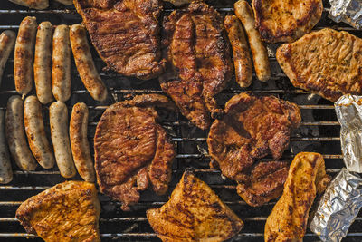 High angle view of meat on barbecue grill