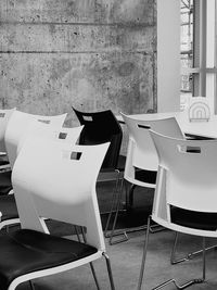 Empty chairs and tables in front of building