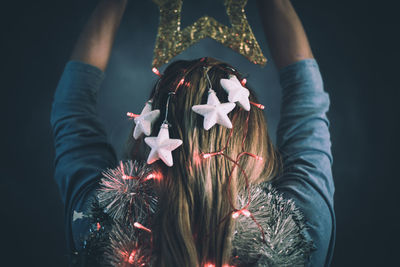 Rear view of woman with star shape decoration