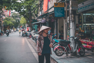 Man with bicycle on street in city