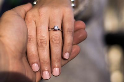 Close-up of cropped hands with wedding ring