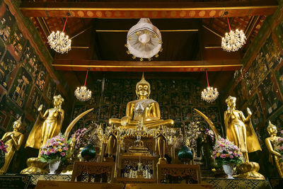 Low angle view of statue against illuminated building