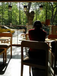 Rear view of woman sitting in cafe